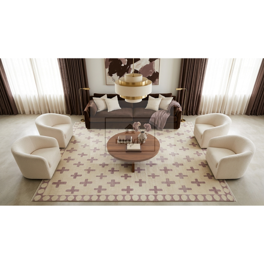 A staged living room scene showing a coordinated furniture set: four cream armchairs arranged around a round wooden coffee table on a patterned cream rug, with a dark sofa and wall art in the background.