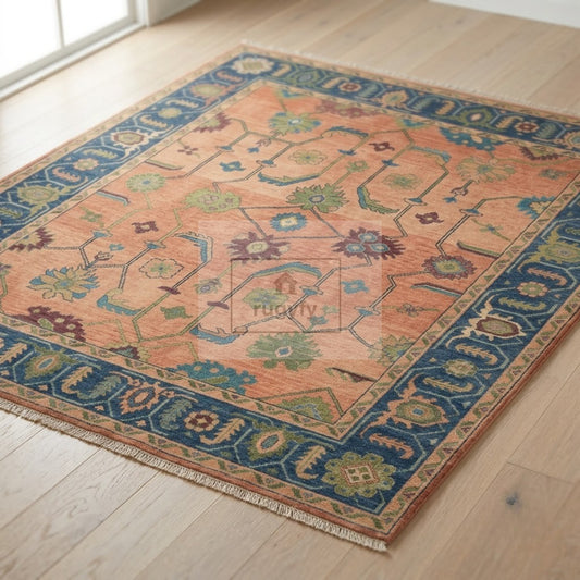 Coral and navy blue Sultanabad Oushak rug hand-knotted in New Zealand wool with sage green palmettes on a light oak floor - RUGYFY