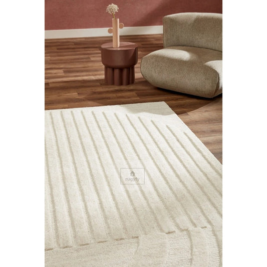 Cream sculpted high-low carved line minimalist hand-tufted wool rug in a modern living room