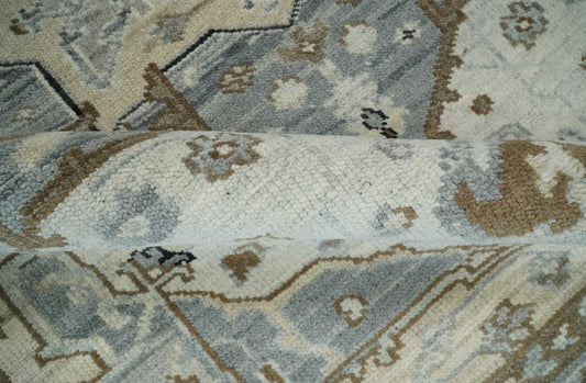 Close-up of a patterned rug with geometric designs in blue, brown, and beige.