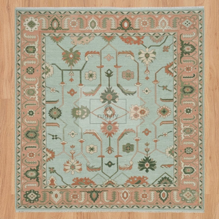 Full view of seafoam aqua and coral peach Sultanabad Oushak rug hand-knotted in New Zealand wool with green palmettes - RUGYFY